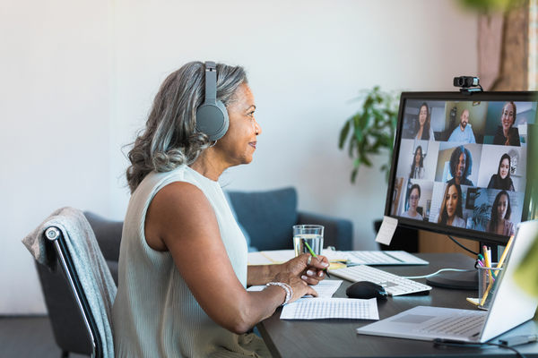 Senior CEO leads a team meeting online.